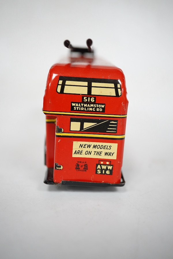 A boxed Wells Brimtoy tinplate clockwork trolley bus loosely in London Transport livery, together with three keys. Condition fair to good, clockwork motor appears to work correctly although has lost grip on the driving a